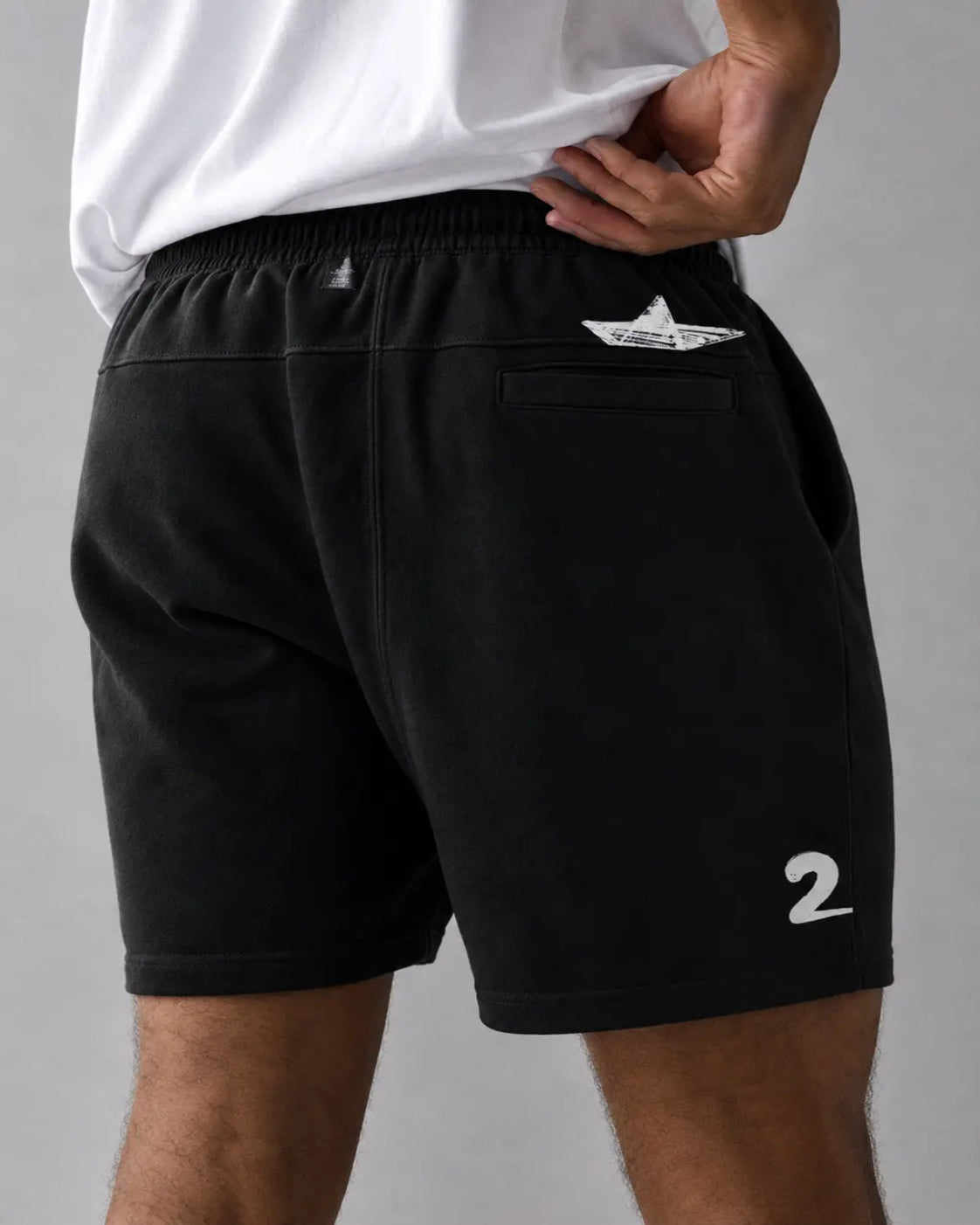 Black shorts with a white logo and number on a gray background