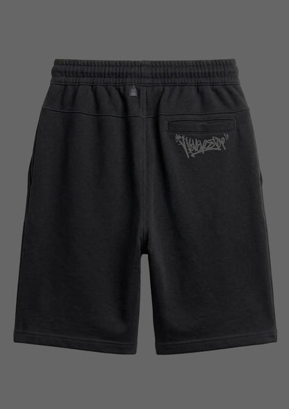 Black shorts with a logo on the back pocket against a light gray background